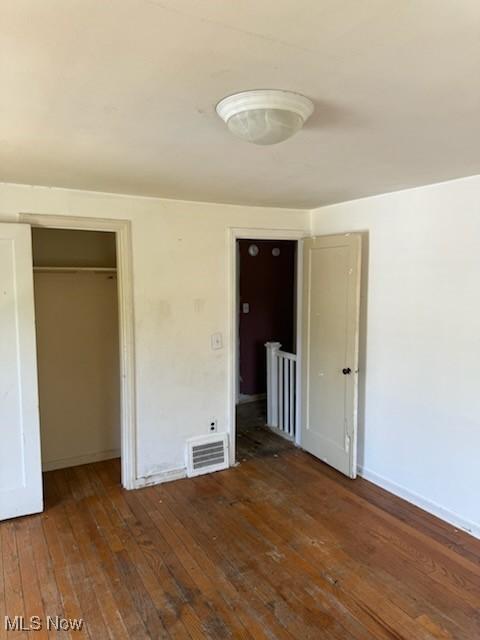 21931 Crystal Ave, Euclid, OH 44123 - unfurnished bedroom featuring hardwood / wood-style flooring, a closet, and baseboards