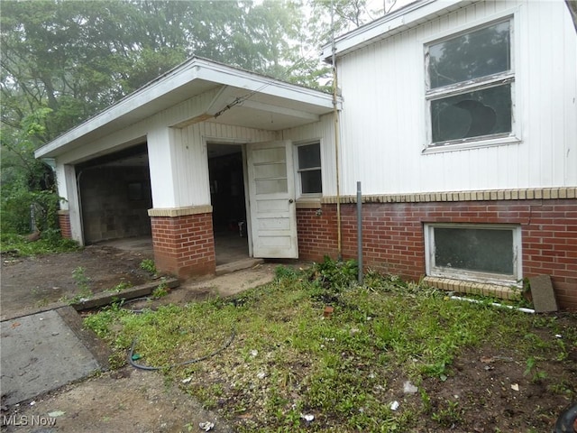 52100 State Route 536, Hannibal, OH 43915 - view of front of property with brick siding and a garage