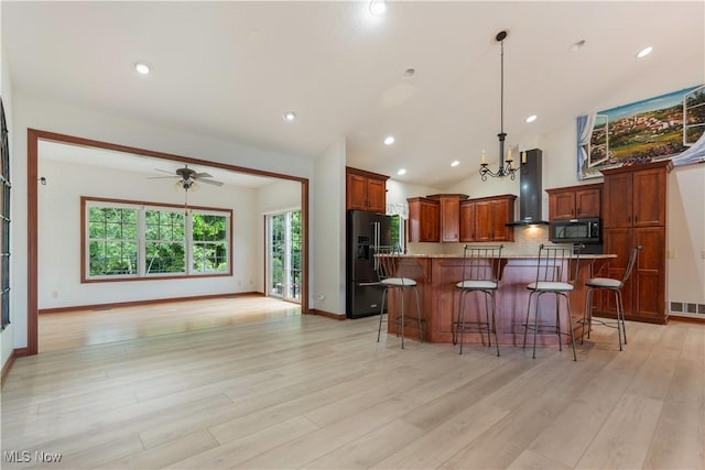 4953 Maclaren Ave NW, Massillon, OH 44646 - kitchen featuring wall chimney exhaust hood, black appliances, vaulted ceiling, a chandelier, and a kitchen bar