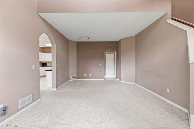 7284 Forest Cove Ln, Northfield, OH 44067 - unfurnished room with arched walkways, light colored carpet, and baseboards
