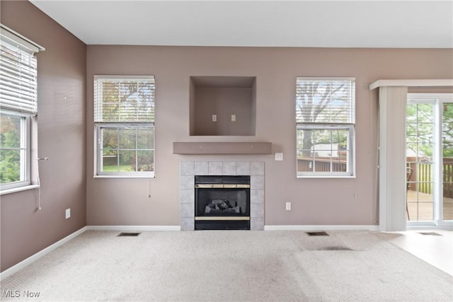 7284 Forest Cove Ln, Northfield, OH 44067 - unfurnished living room with a tiled fireplace, baseboards, and carpet flooring