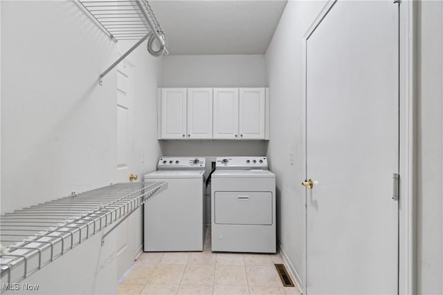 7284 Forest Cove Ln, Northfield, OH 44067 - laundry area featuring cabinet space, independent washer and dryer, and light tile patterned flooring