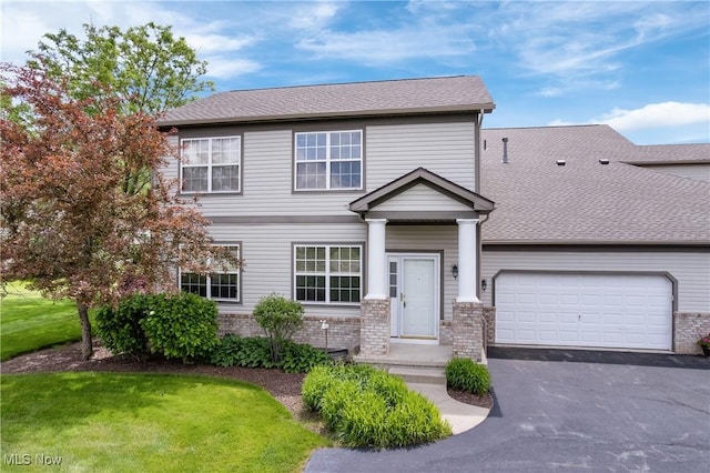 7284 Forest Cove Ln, Northfield, OH 44067 - view of front facade featuring brick siding, a garage, asphalt driveway, and a front yard