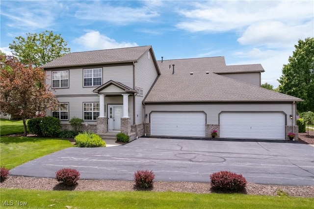 7284 Forest Cove Ln, Northfield, OH 44067 - view of front of house featuring a garage, driveway, brick siding, and roof with shingles