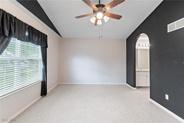 7284 Forest Cove Ln, Northfield, OH 44067 - empty room with lofted ceiling, arched walkways, ceiling fan, light carpet, and baseboards