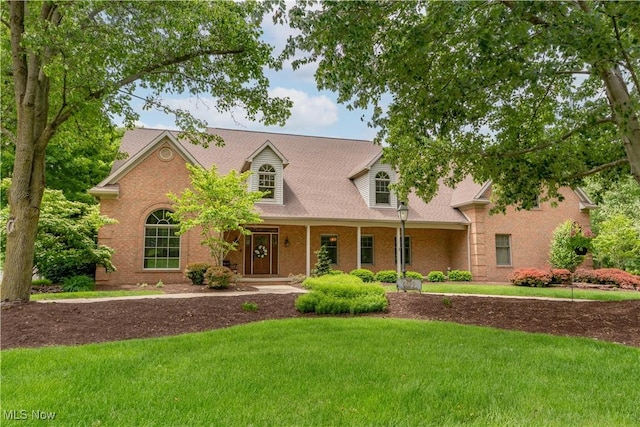 5679 Carters Grove Cir NW, Massillon, OH 44646 - view of front of house featuring a front yard, brick siding, and covered porch