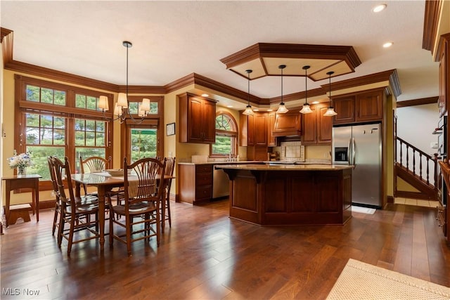 5679 Carters Grove Cir NW, Massillon, OH 44646 - kitchen featuring appliances with stainless steel finishes, a chandelier, dark wood-type flooring, a center island, and ornamental molding