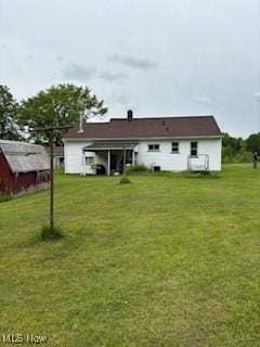 5806 Risher Rd, Leavittsburg, OH 44430 - back of house featuring a lawn