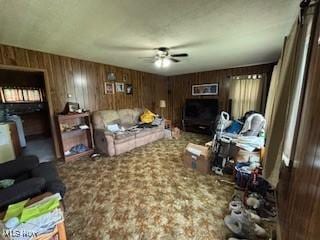 5806 Risher Rd, Leavittsburg, OH 44430 - living room with ceiling fan and wood walls