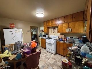5806 Risher Rd, Leavittsburg, OH 44430 - kitchen with white appliances and brown cabinetry