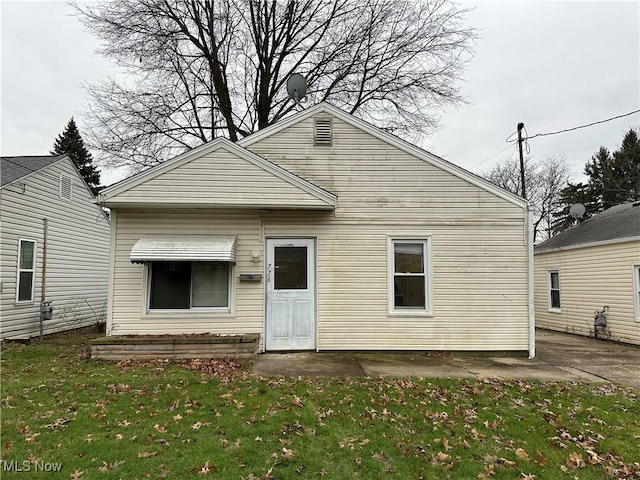 776 Triplett Blvd, Akron, OH 44306 - rear view of property with a lawn and a patio area