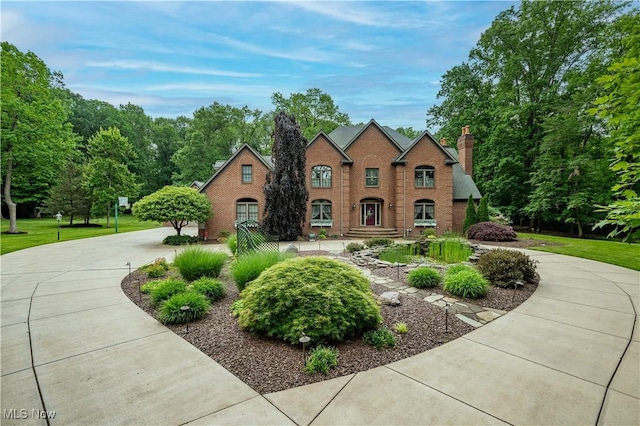 4219 Olde Charted Trl, Poland, OH 44514 - traditional-style house with a chimney, curved driveway, and brick siding