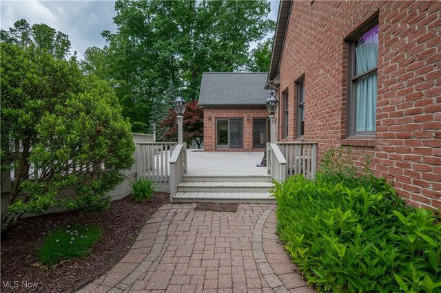 4219 Olde Charted Trl, Poland, OH 44514 - doorway to property with brick siding and a deck