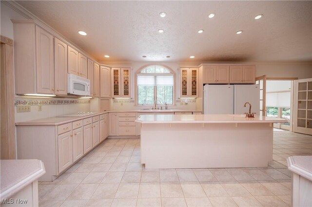 4219 Olde Charted Trl, Poland, OH 44514 - kitchen with white appliances, recessed lighting, a sink, glass insert cabinets, and light countertops