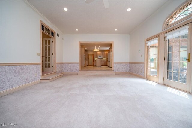 4219 Olde Charted Trl, Poland, OH 44514 - unfurnished living room with carpet floors, wainscoting, ornamental molding, plenty of natural light, and recessed lighting