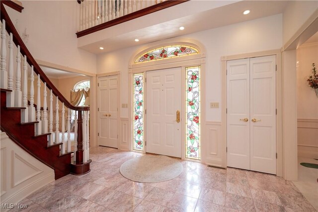4219 Olde Charted Trl, Poland, OH 44514 - foyer entrance with a decorative wall, wainscoting, recessed lighting, and stairs