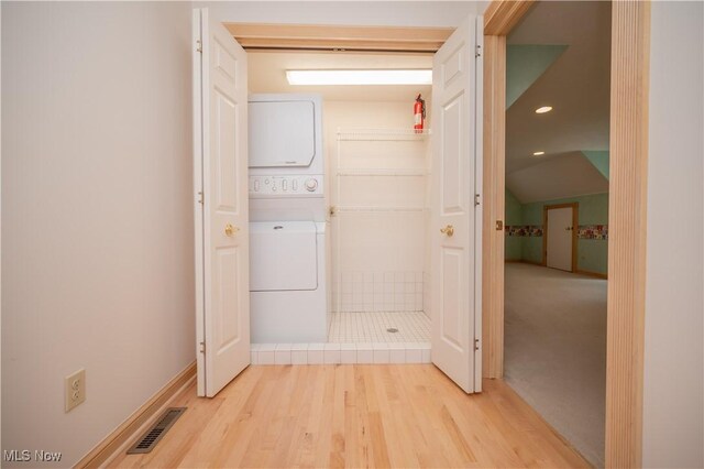 4219 Olde Charted Trl, Poland, OH 44514 - laundry area featuring stacked washer / drying machine, light wood-style floors, recessed lighting, and baseboards