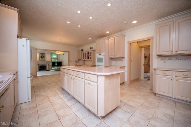 4219 Olde Charted Trl, Poland, OH 44514 - kitchen featuring white appliances, light countertops, recessed lighting, a fireplace with raised hearth, and a textured ceiling