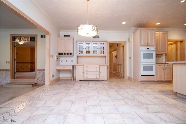 4219 Olde Charted Trl, Poland, OH 44514 - kitchen featuring white double oven, crown molding, glass insert cabinets, light tile patterned floors, and light countertops