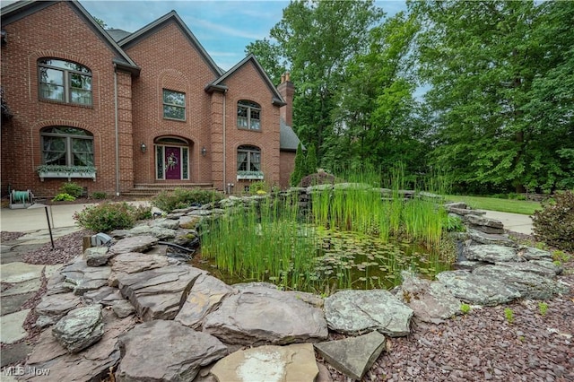 4219 Olde Charted Trl, Poland, OH 44514 - view of front of home featuring brick siding and a chimney
