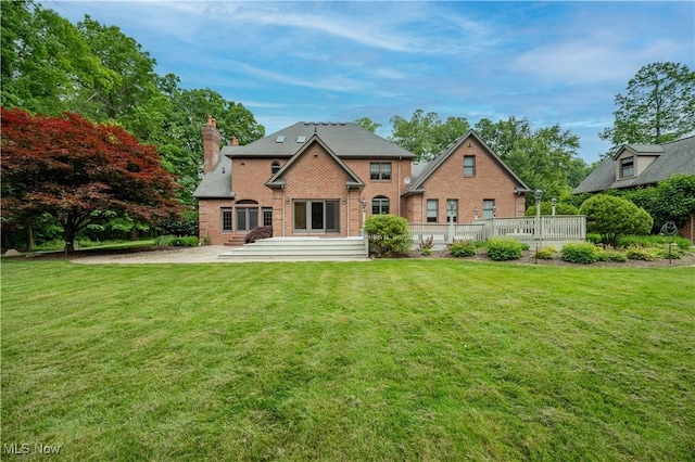 4219 Olde Charted Trl, Poland, OH 44514 - rear view of property with brick siding, a chimney, and a lawn