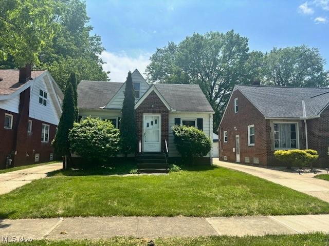 19800 Meredith Ave, Euclid, OH 44119 - bungalow-style house featuring a front yard, brick siding, and entry steps