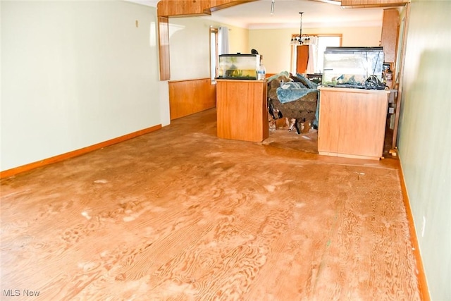 122 21st St NW, Barberton, OH 44203 - kitchen featuring baseboards, brown cabinets, hanging light fixtures, and open floor plan
