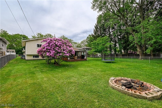 488 Spaulding Dr, Kent, OH 44240 - view of yard with a trampoline, a fire pit, and a deck