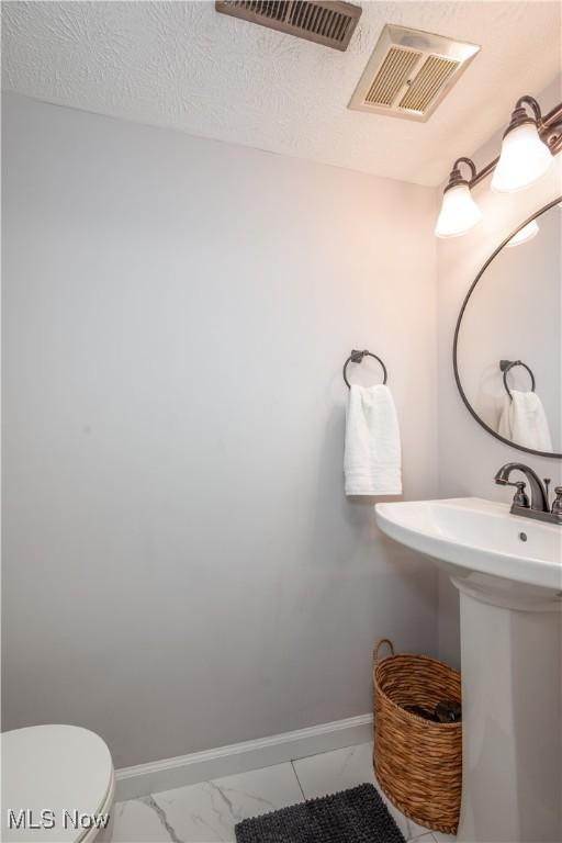 488 Spaulding Dr, Kent, OH 44240 - bathroom featuring marble finish floors, baseboards, toilet, and a sink
