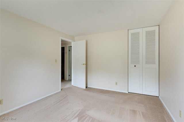 4285 Baird Rd, Stow, OH 44224 - unfurnished bedroom featuring a closet, light carpet, and baseboards