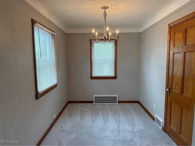 22561 Chardon Rd, Euclid, OH 44117 - carpeted empty room with plenty of natural light, a chandelier, baseboards, and crown molding