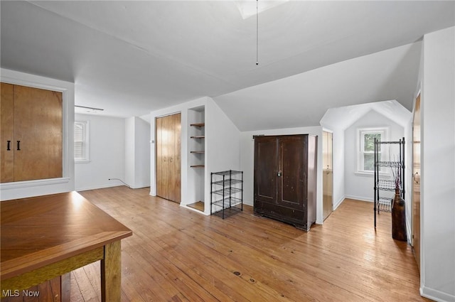 14300 Bidwell Ave, Cleveland, OH 44111 - bonus room featuring light wood-style floors, built in shelves, baseboards, and vaulted ceiling