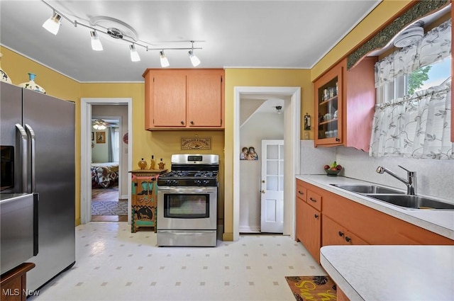 14300 Bidwell Ave, Cleveland, OH 44111 - kitchen with appliances with stainless steel finishes, a sink, light floors, light countertops, and glass insert cabinets