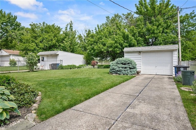 14300 Bidwell Ave, Cleveland, OH 44111 - view of yard featuring concrete driveway, a garage, and an outdoor structure