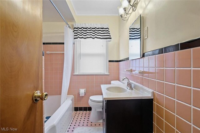 14300 Bidwell Ave, Cleveland, OH 44111 - full bathroom with toilet, tile walls, vanity, shower / bath combo with shower curtain, and crown molding