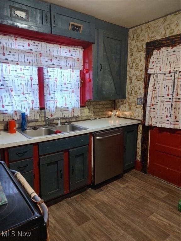 1028 Kenilworth Ave, Coshocton, OH 43812 - kitchen featuring stainless steel dishwasher, wallpapered walls, a sink, dark wood-style flooring, and light countertops