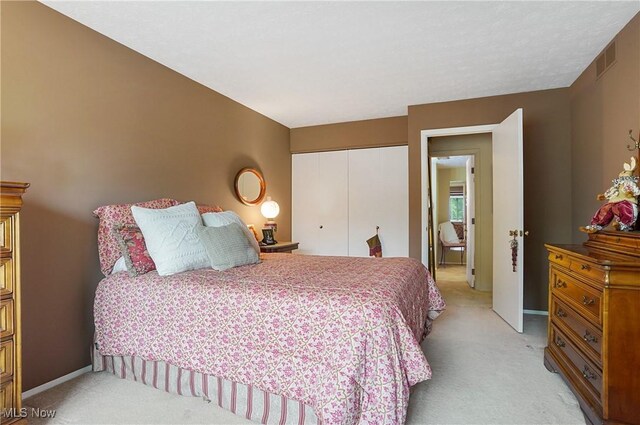 186 Court Dr Unit 201, Fairlawn, OH 44333 - bedroom featuring light carpet, a closet, and baseboards