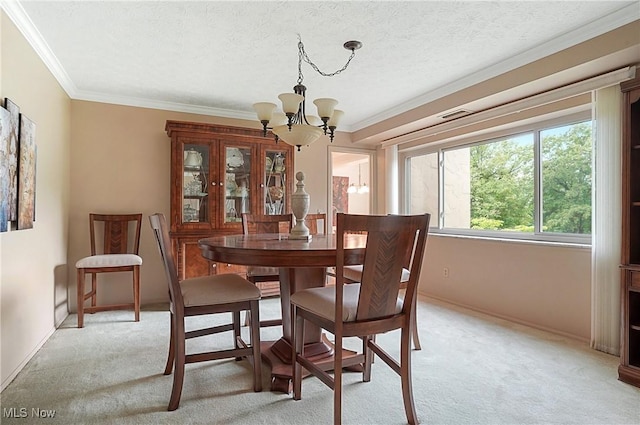186 Court Dr Unit 201, Fairlawn, OH 44333 - dining space with a chandelier, light colored carpet, crown molding, a textured ceiling, and baseboards