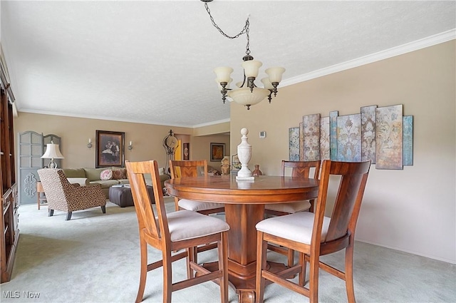 186 Court Dr Unit 201, Fairlawn, OH 44333 - dining area with a chandelier, light colored carpet, ornamental molding, a textured ceiling, and baseboards