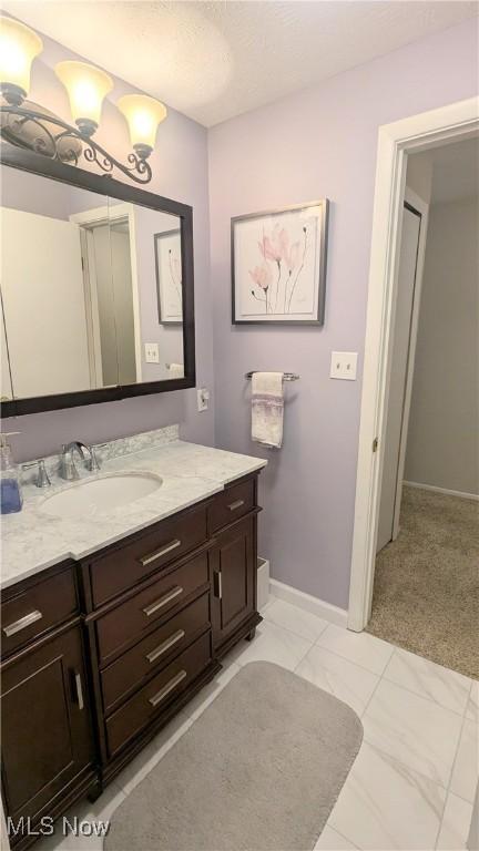 6478 State Rd Unit G8, Parma, OH 44134 - bathroom featuring vanity, baseboards, and marble finish flooring