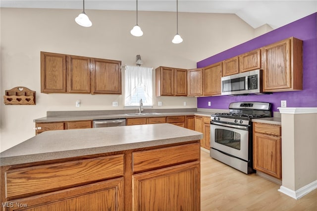 2716 Edgebrook Xing, Twinsburg, OH 44087 - kitchen featuring stainless steel appliances, a sink, vaulted ceiling, light wood finished floors, and pendant lighting