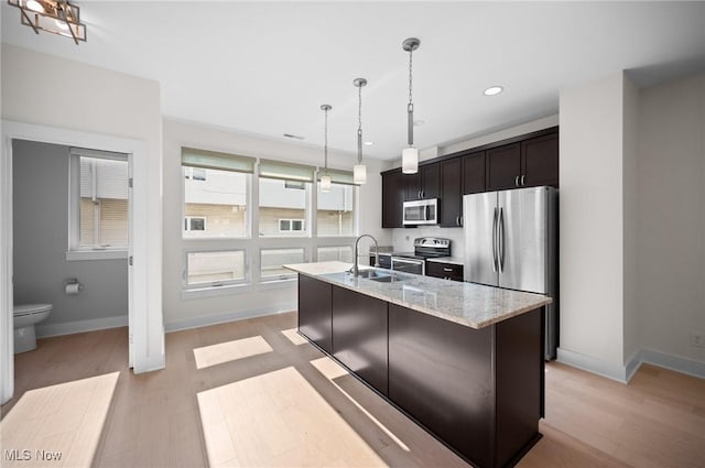 1257 W 75th St Unit D1257, Cleveland, OH 44102 - kitchen featuring stainless steel appliances, a sink, light wood-style floors, baseboards, and recessed lighting