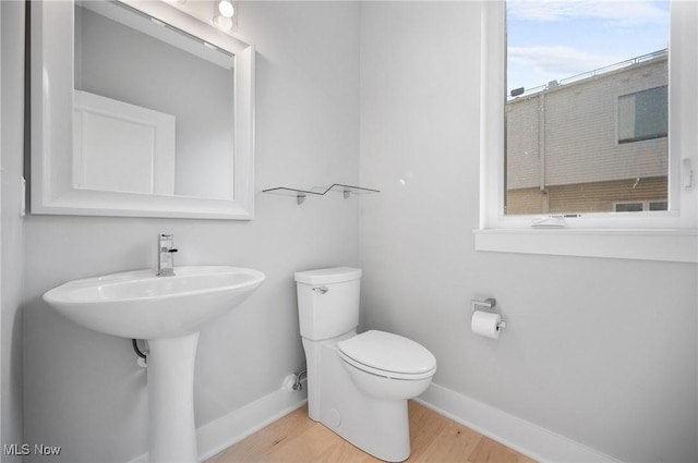1257 W 75th St Unit D1257, Cleveland, OH 44102 - half bathroom with baseboards, toilet, and wood finished floors