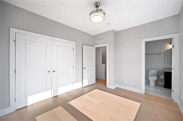 1257 W 75th St Unit D1257, Cleveland, OH 44102 - unfurnished bedroom with light wood-type flooring, baseboards, a closet, and ensuite bath