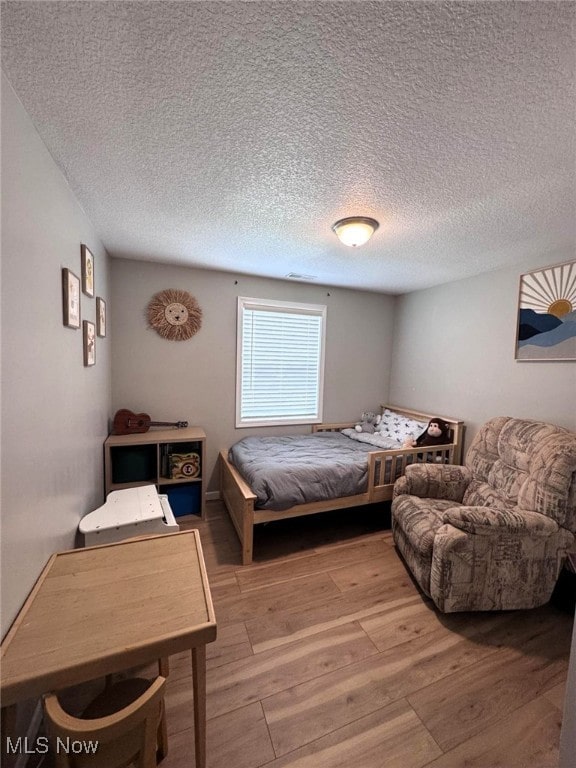 2187 State Route 550, Cutler, OH 45724 - bedroom with wood finished floors and a textured ceiling