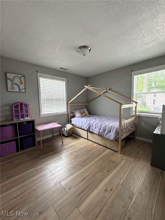 2187 State Route 550, Cutler, OH 45724 - bedroom featuring hardwood / wood-style floors and a textured ceiling