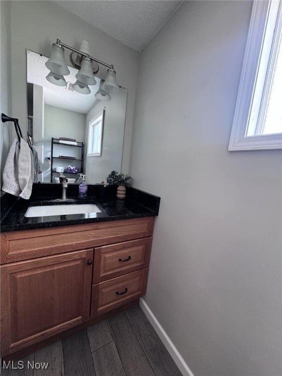 2187 State Route 550, Cutler, OH 45724 - bathroom featuring wood finished floors, vanity, and a textured ceiling