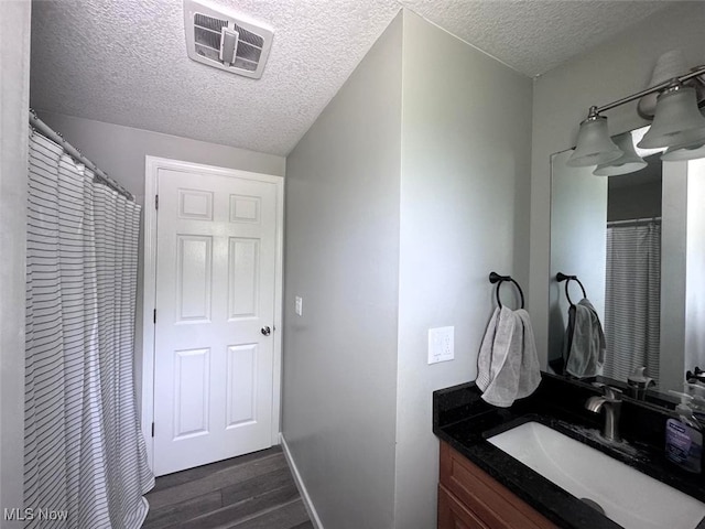 2187 State Route 550, Cutler, OH 45724 - bathroom featuring a textured ceiling, wood finished floors, and vanity
