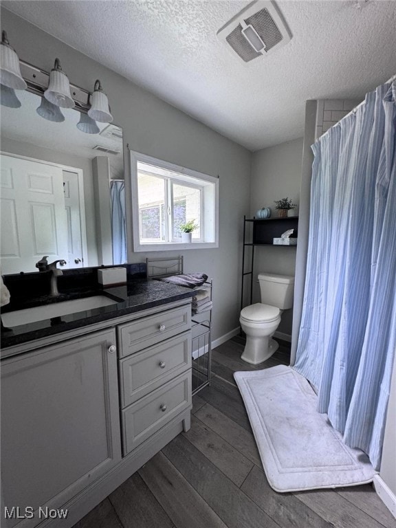 2187 State Route 550, Cutler, OH 45724 - full bathroom featuring vanity, a textured ceiling, wood finished floors, and a shower with curtain