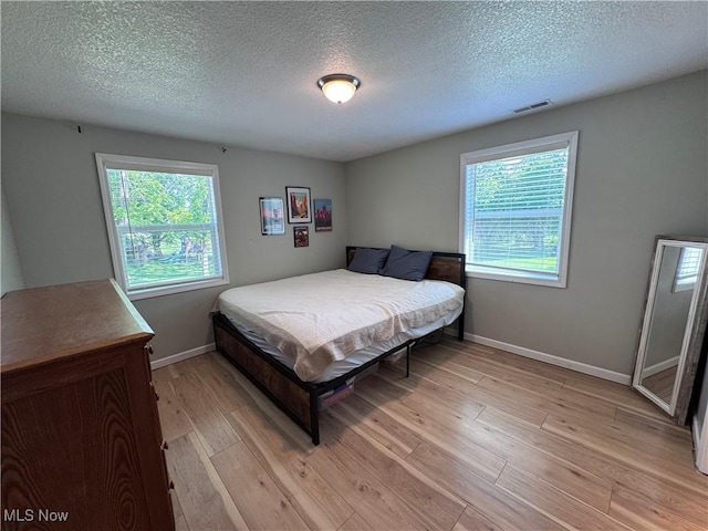 2187 State Route 550, Cutler, OH 45724 - bedroom with light wood-style floors and a textured ceiling